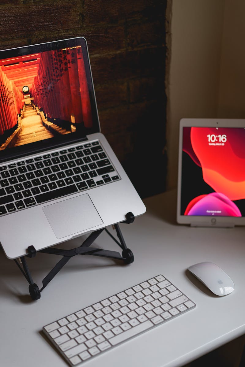 Un ordinateur portable est posé sur un bureau à côté d'une souris et d'un clavier.